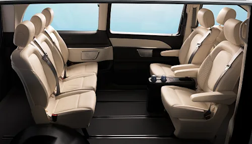The inside of a Blacklane business van showing three back seats facing three more.