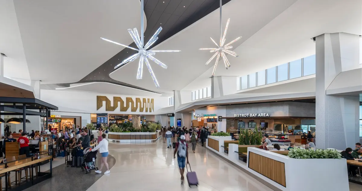 Interior shot of the foodcourt area of the Harvey Milk Terminal of San Francisco Airport, with its sharp design and high ceilings.