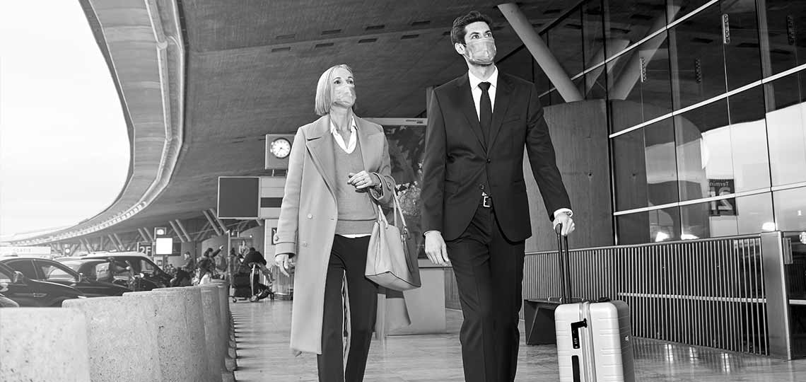 1140 px / 540 px Chauffeur walking with guest and luggage at arrivals with masks