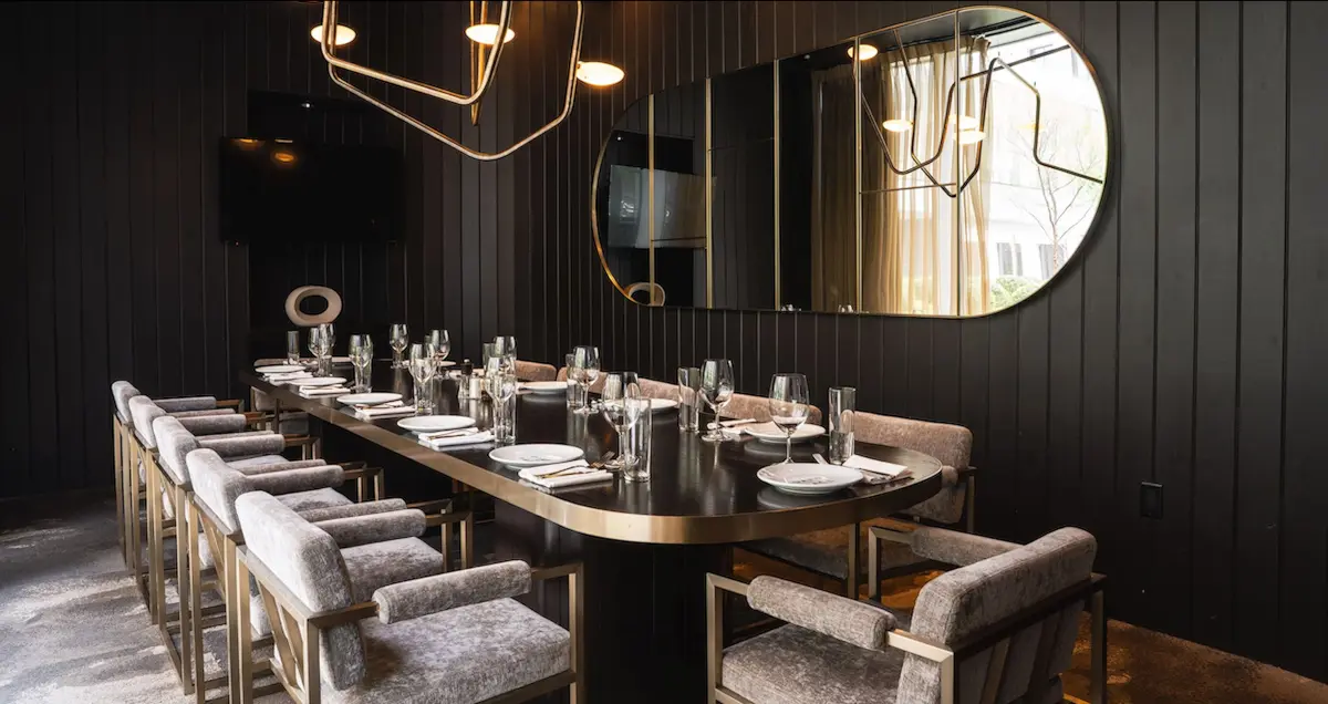 Shot of the Houston private dining room The Boardroom in Guard and Grace restaurant, showing a table fully set for dinner.