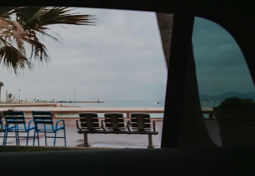 Shot of a Mediterranean marina on a cloudy day through the window of a luxury car.