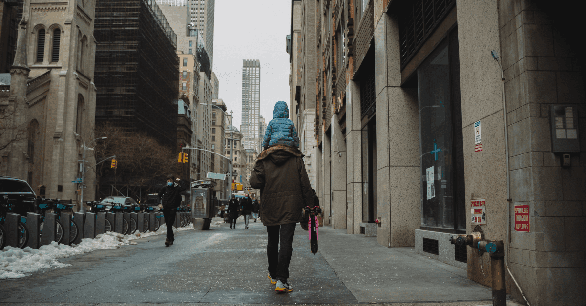 <figcaption>A man walking down a New York street with his daughter on his shoulders. <em>Image credit: ibuki Tsubo</em>/Unsplash</figcaption>