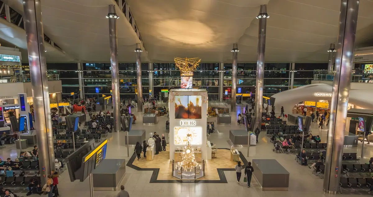 Heathrow airport terminal 2 departure lounge, showing a huge Dior counter and Louis Vuitton shop.