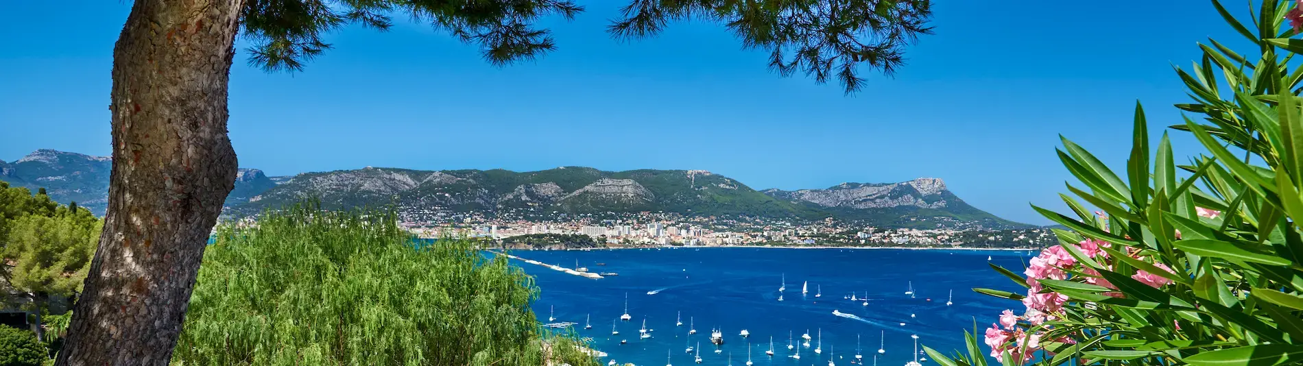 Beautiful coastal Toulon, sharp blue skies against the softer indigo of the ocean, punctuated by flashes of green foliage on the adjoining hillside.