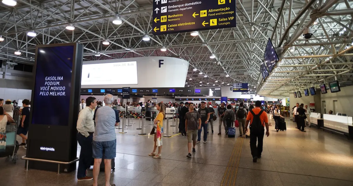 Interior shot of passengers walking inside the terminal in the Galeao International airport in Rio De Janeiro, Brazil.