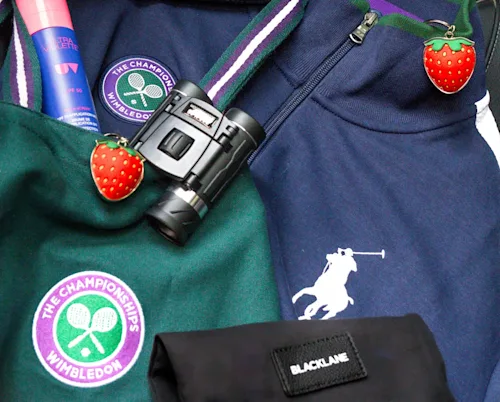 Another shot of the Blacklane Wimbledon goody bag with binoculars, Ralph Lauren ballboy jacket, and strawberry souvenirs.