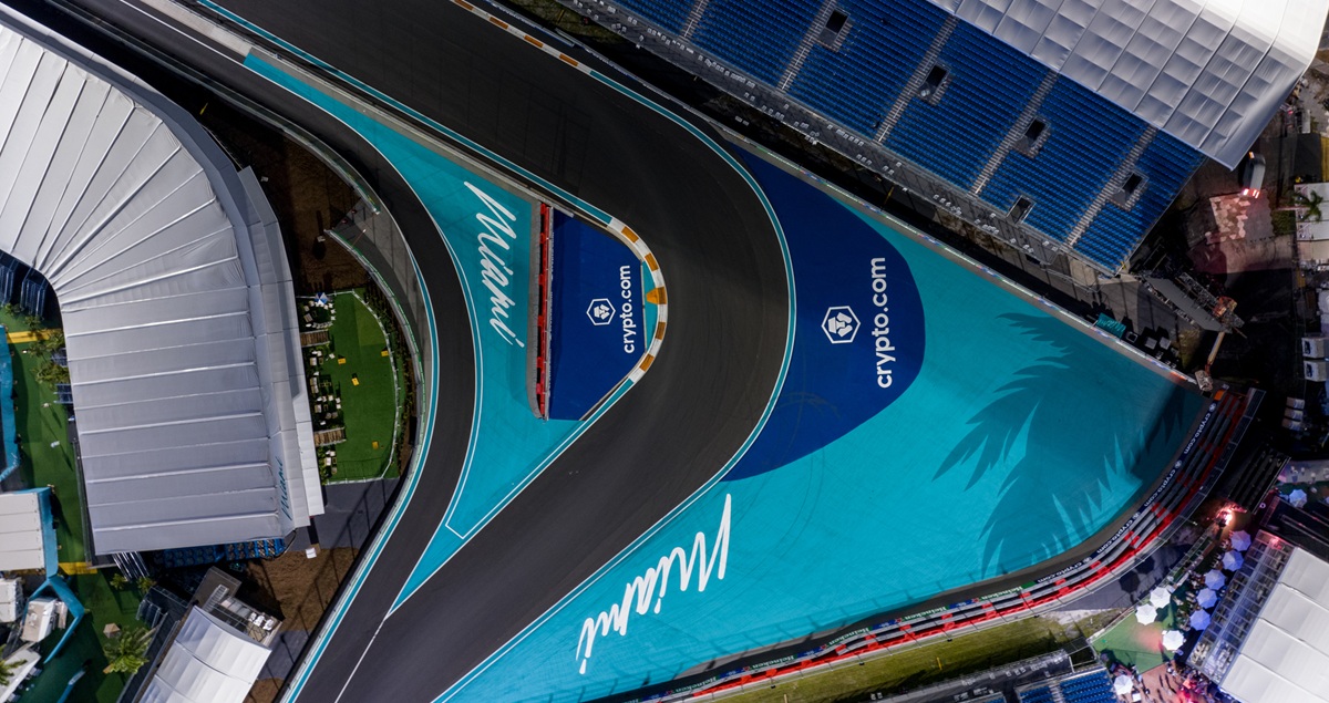 Bird's eye view shot of Turn 1 of the Miami F1 GP track at nighttime during construction, showing the gravel trap and a grandstand.