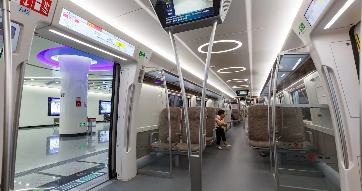 Interior shot of Airport Express train Beijing Daxing MRT Metro and a platform beyond.