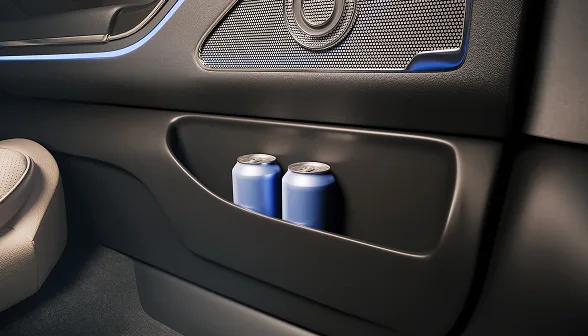 Shot of two cans of water in the door of a Blacklane First Class vehicle interior.