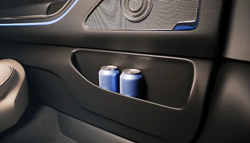 Shot of two cans of water in the door of a Blacklane First Class vehicle interior.