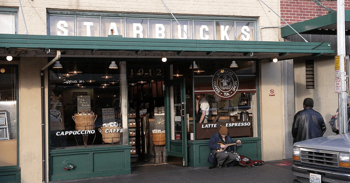 <figcaption class="wp-element-caption">Starbucks' journey started in 1971, right among the cobblestone streets of Seattle's iconic Pike Place Market.<em> Image credit: Wikimedia</em></figcaption>