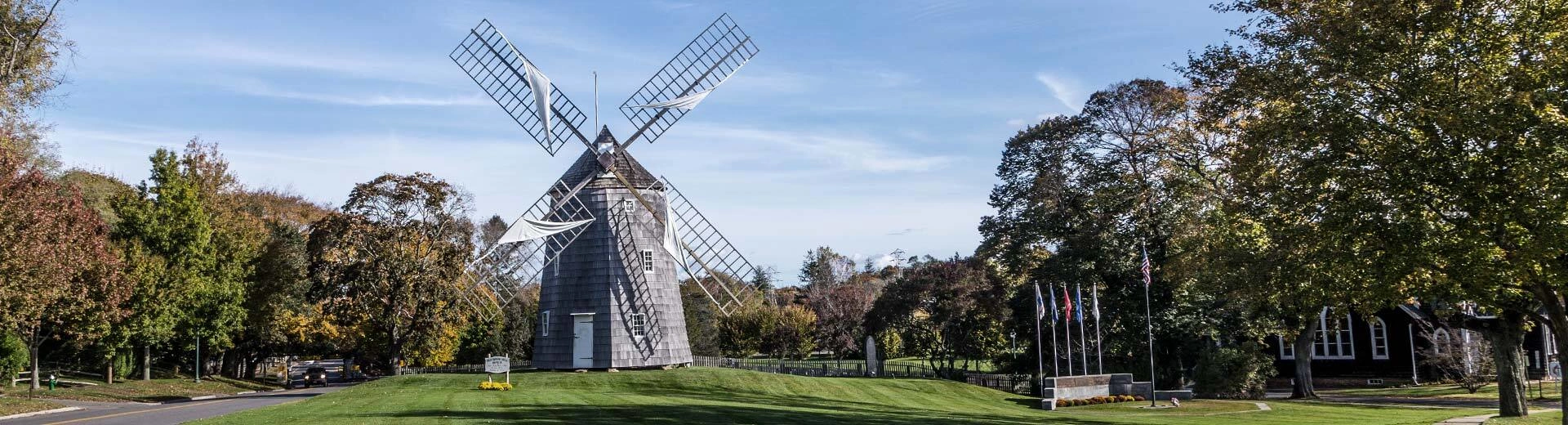 A lighthouse sits on a the grassy coastline of East Hampton.