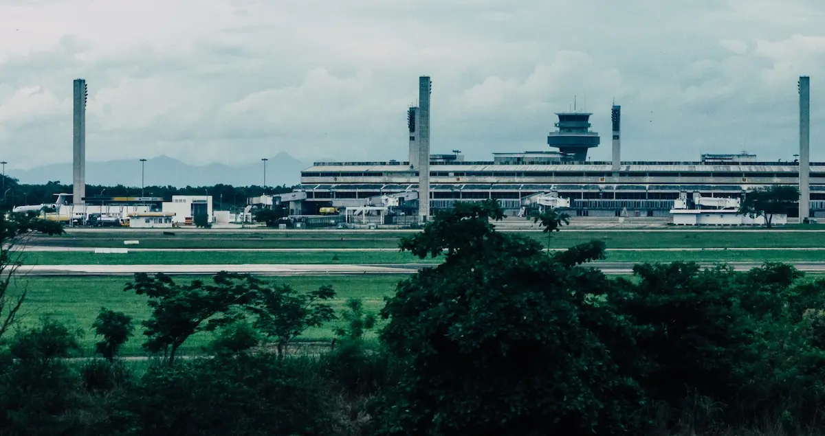 View of GIG airport in Rio De Janeiro in Brazil, showing the runways with the terminal building and control tower behind it.