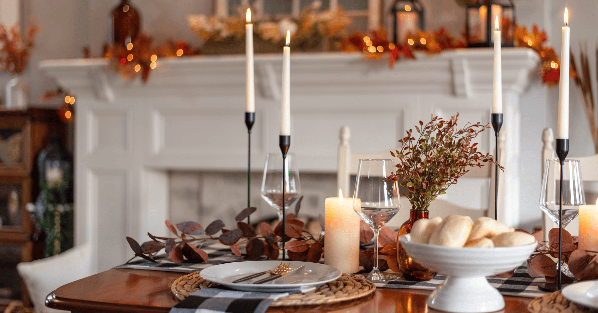 <figcaption class="wp-element-caption">The Thanksgiving table is adorned with fall-colored linens, candles, and centerpieces of pumpkins and leaves, creating a warm and festive atmosphere. <em>Image credit: Kristen Prahl/Gettyimages</em></figcaption>