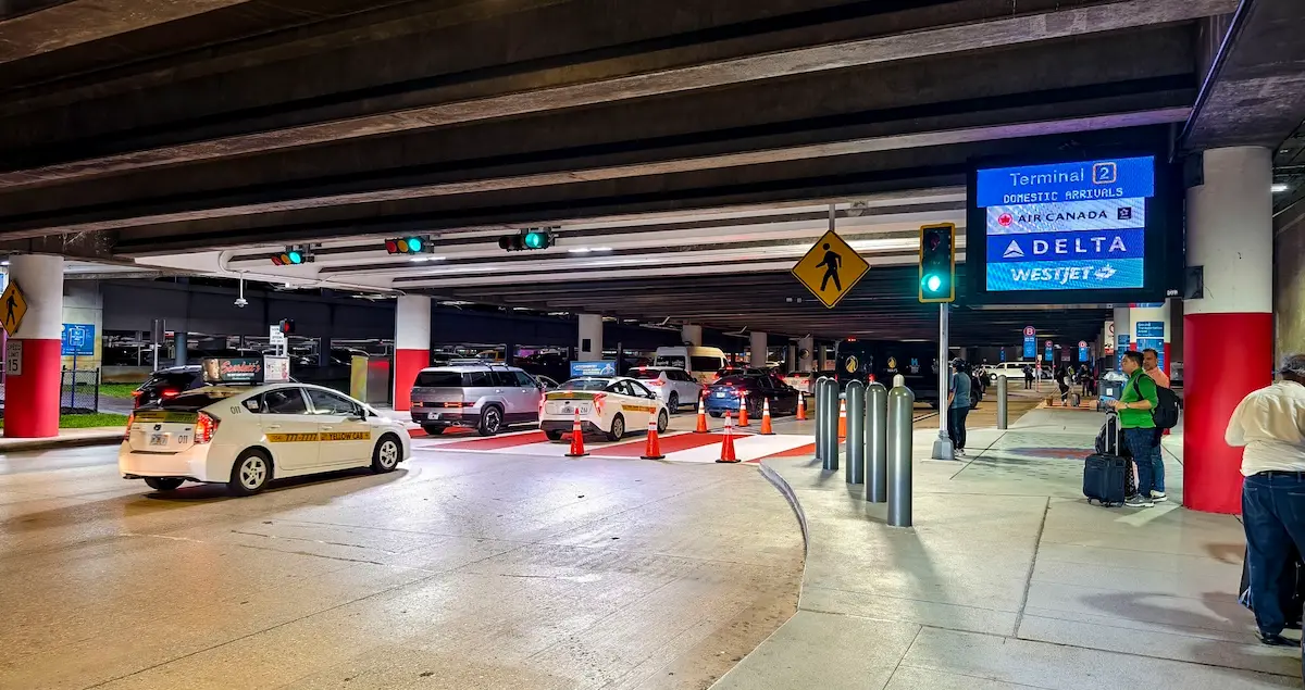 Fort Lauderdale-Hollywood International Airport arrival area showing traffic flow and waiting passengers.