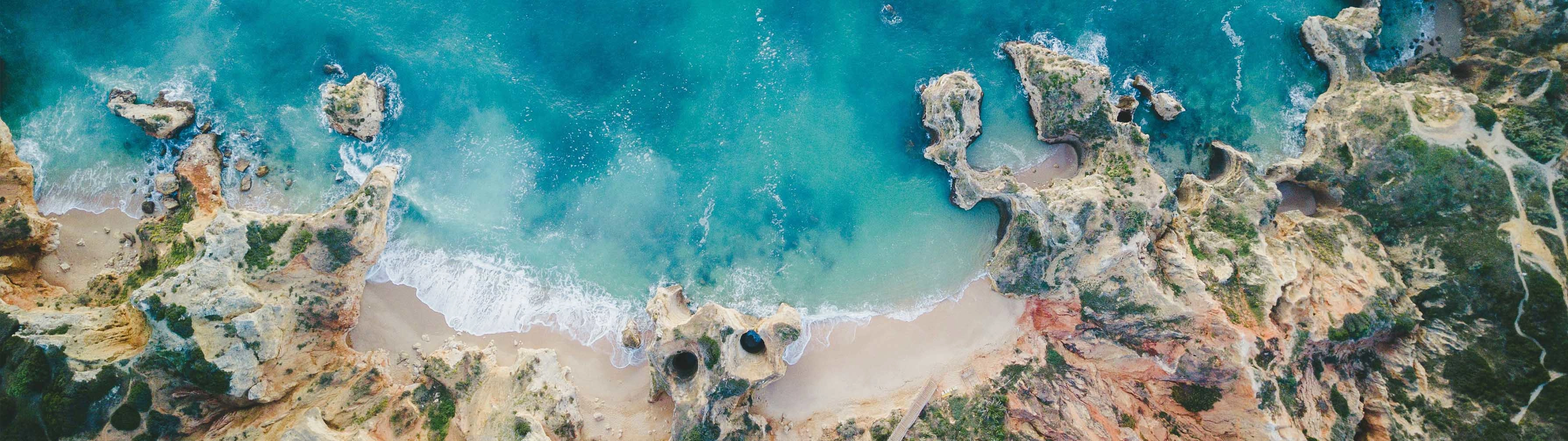 Beautiful turquoise waters touch white sand in beautiful Lagos.