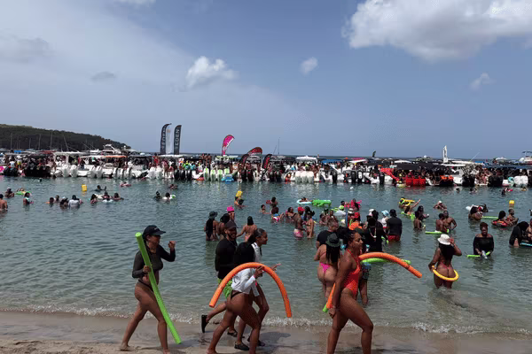 Festivalgoers Enjoying Mercury Beach with Floating Accessories at Grande Anse