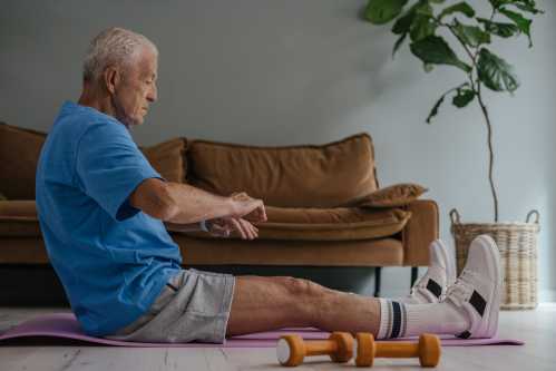 An elderly man doing exercise and stretches within his home