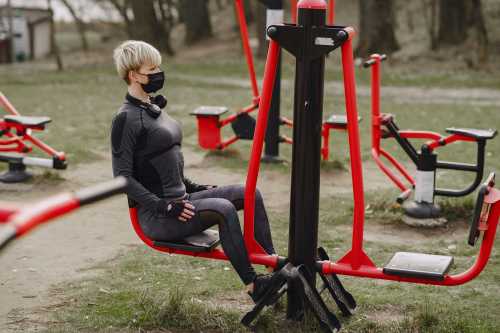 Outdoor gym instructor working out on a shoulder press