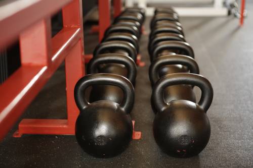 Kettle bell weights on the gym floor ready for the personal training class