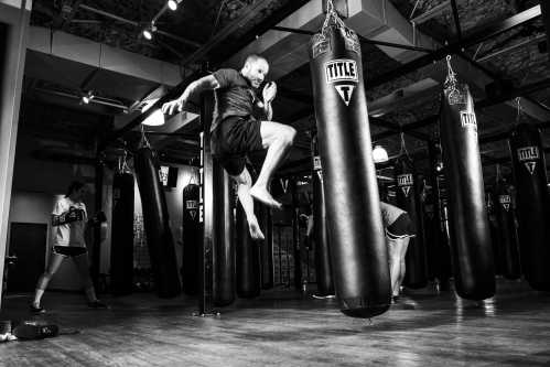 a personal trainer kicking a boxing bag
