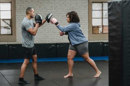 woman boxing with personal trainer