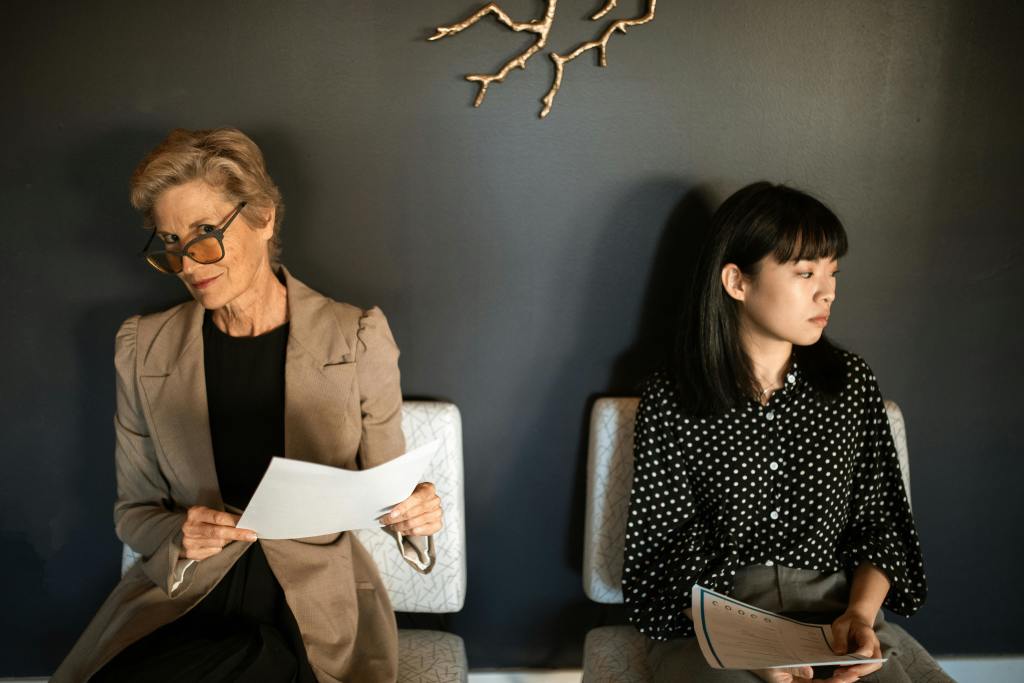 Two women sitting on a chair beside each other