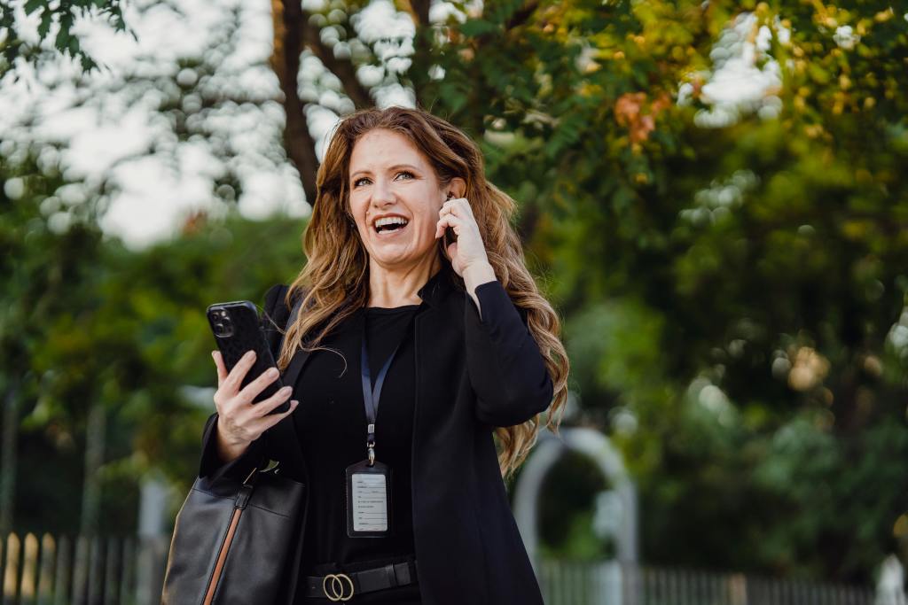 A woman talking on the phone while walking outdoors