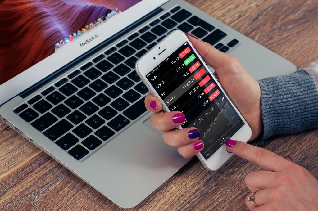 A woman checking stock market prices on her iPhone