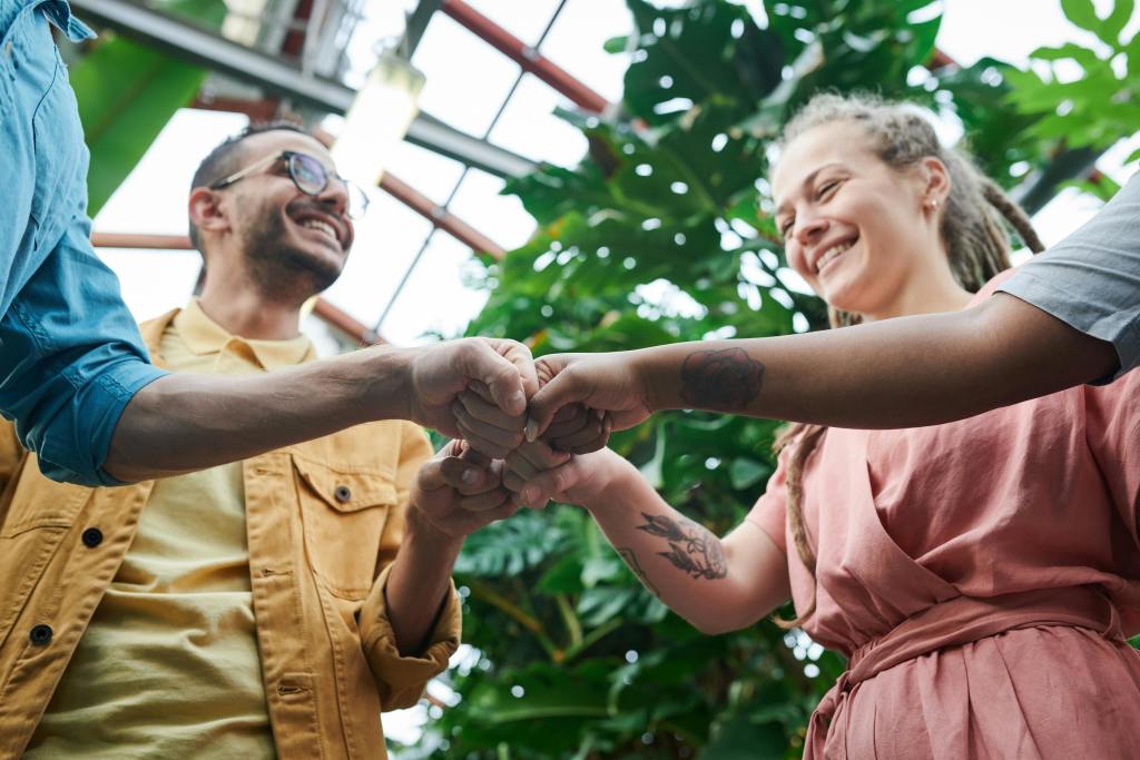 Four people doing a group fist bump