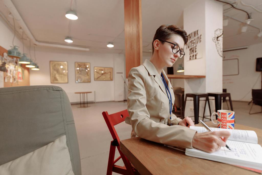 A woman writing on a notebook