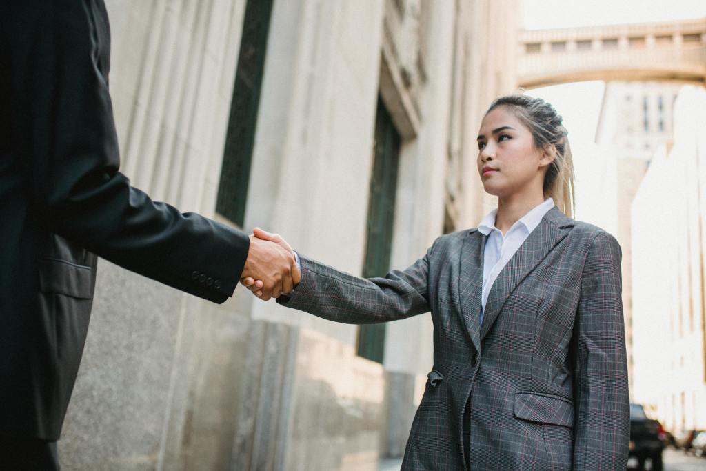 A woman shaking hands with another person