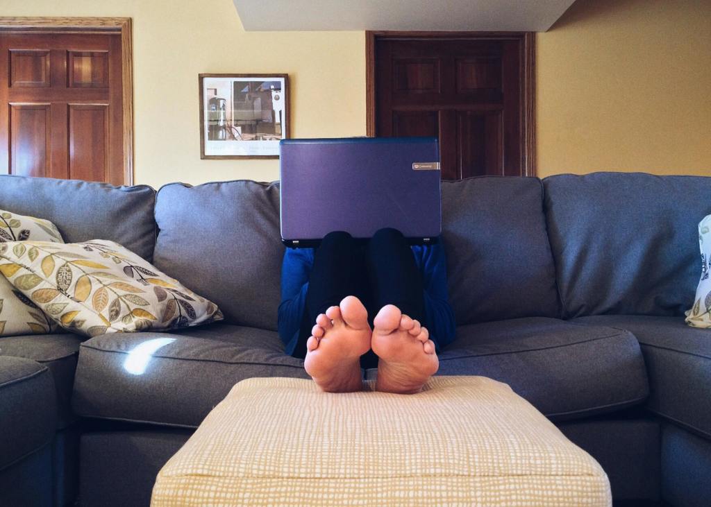 A person using their laptop in their living room