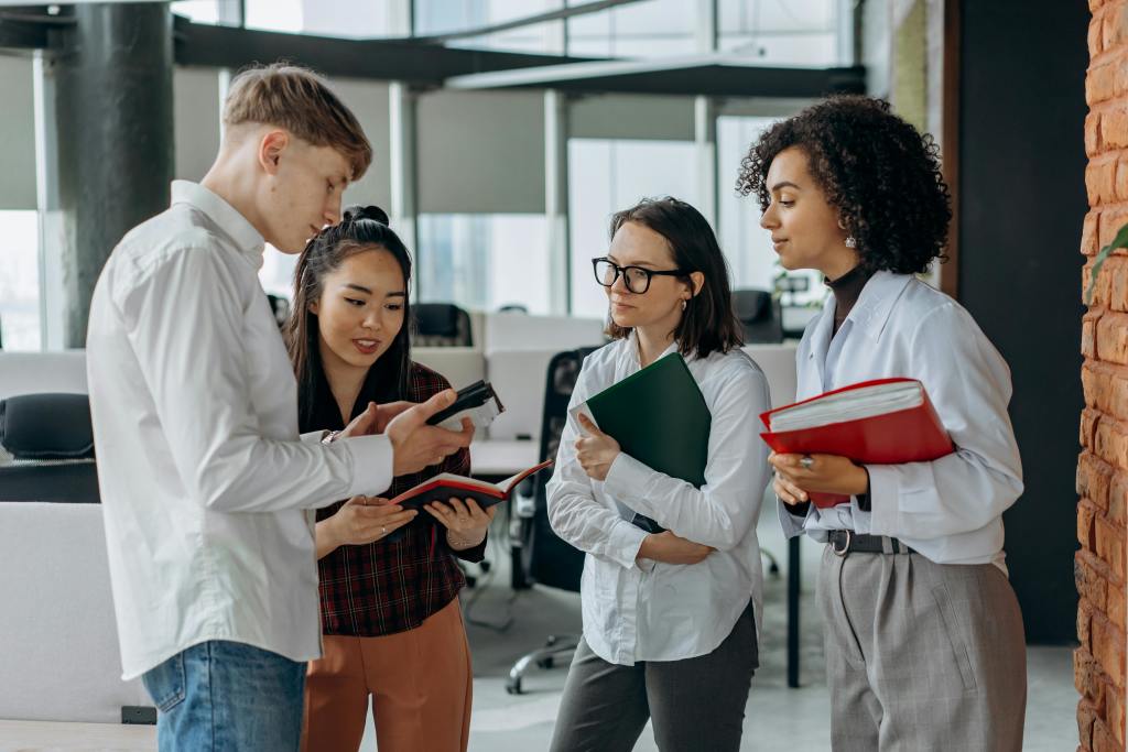 A group of people looking at a mobile device