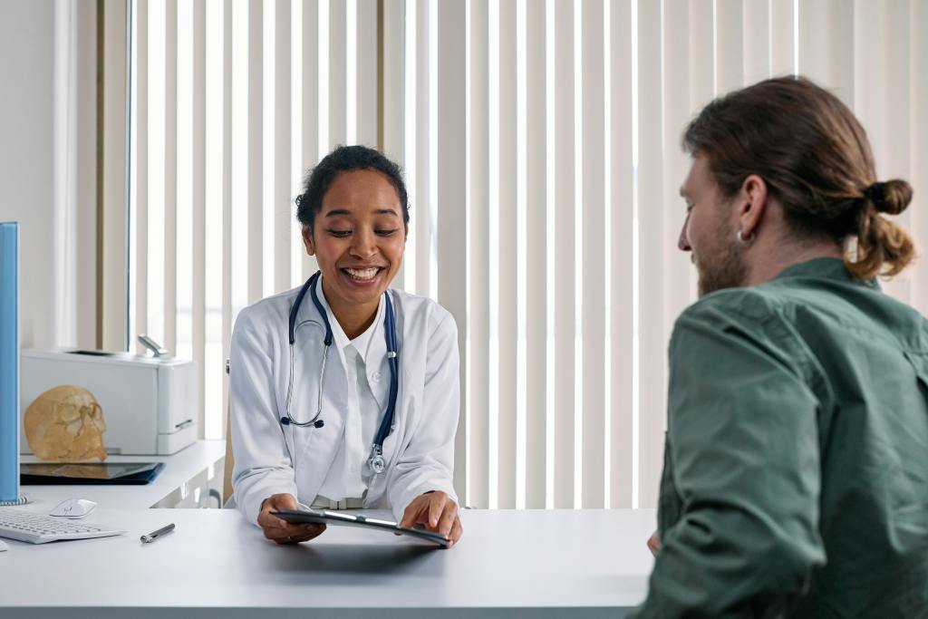 A healthcare professional talking to a patient