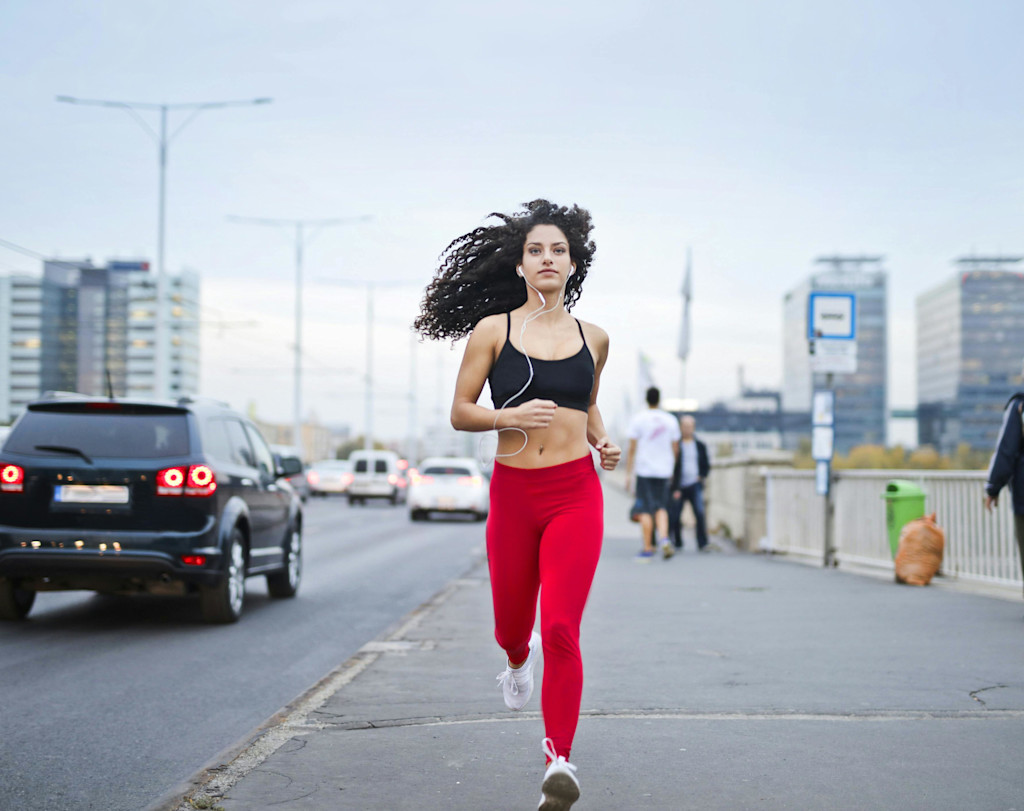 A woman jogging while listening to music