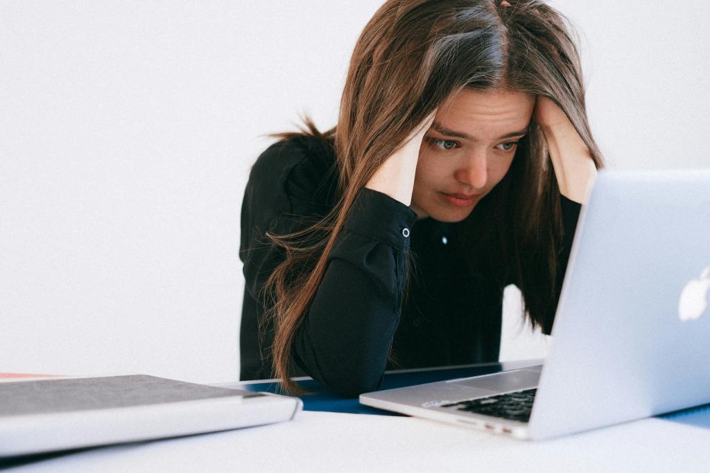 A frustrated woman looking at her laptop