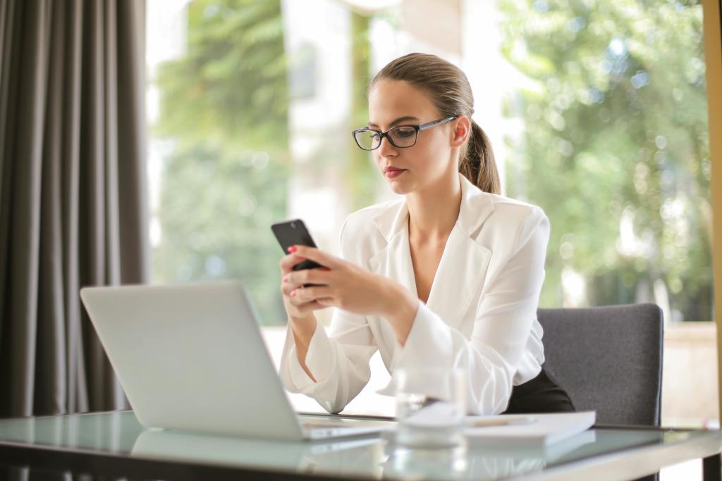 A corporate woman looking at her phone