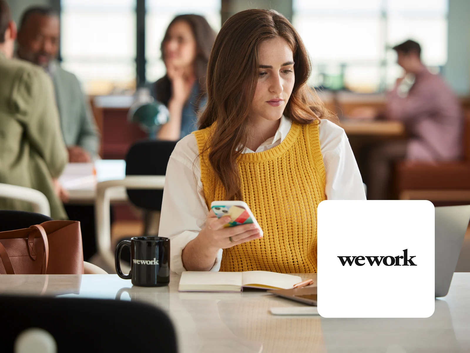 Decorative: Image of woman working at WeWork