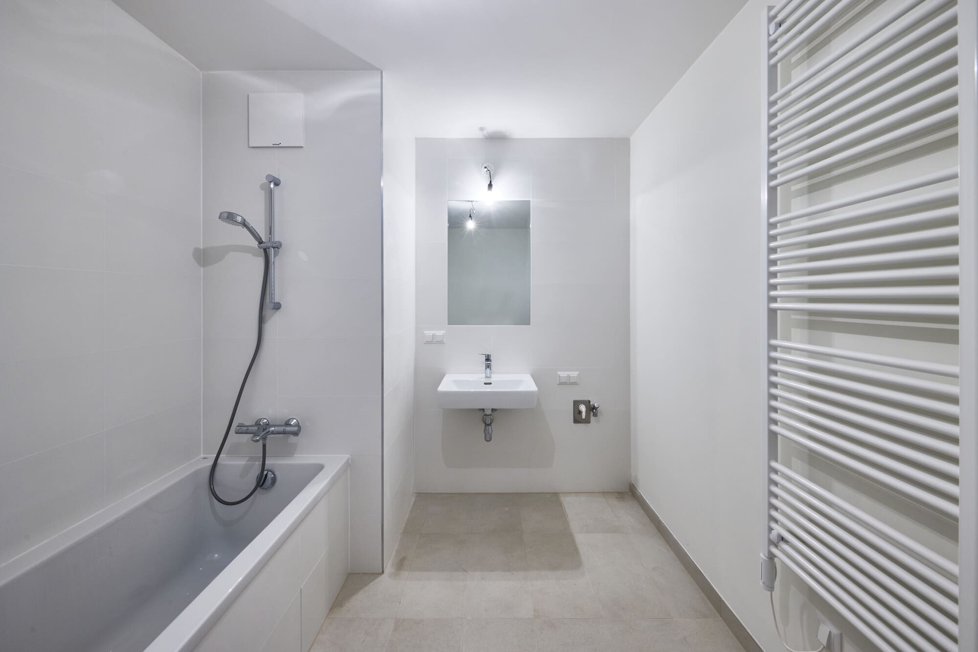 Apartment interior bathroom with bath, radiator and sink