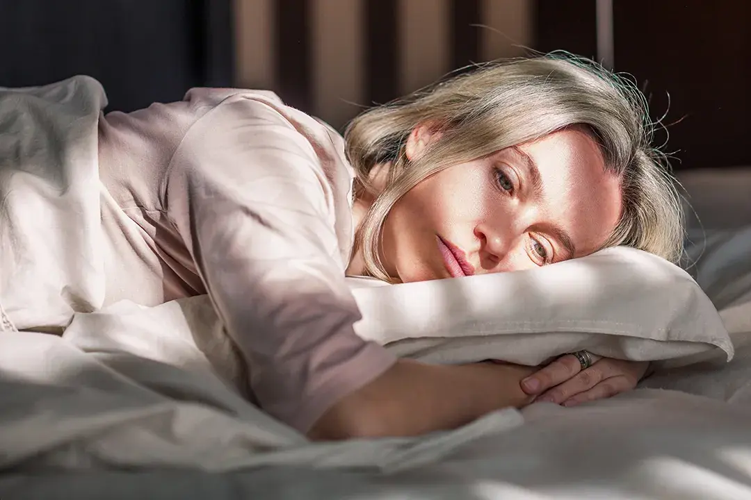 Worried Woman in Bed