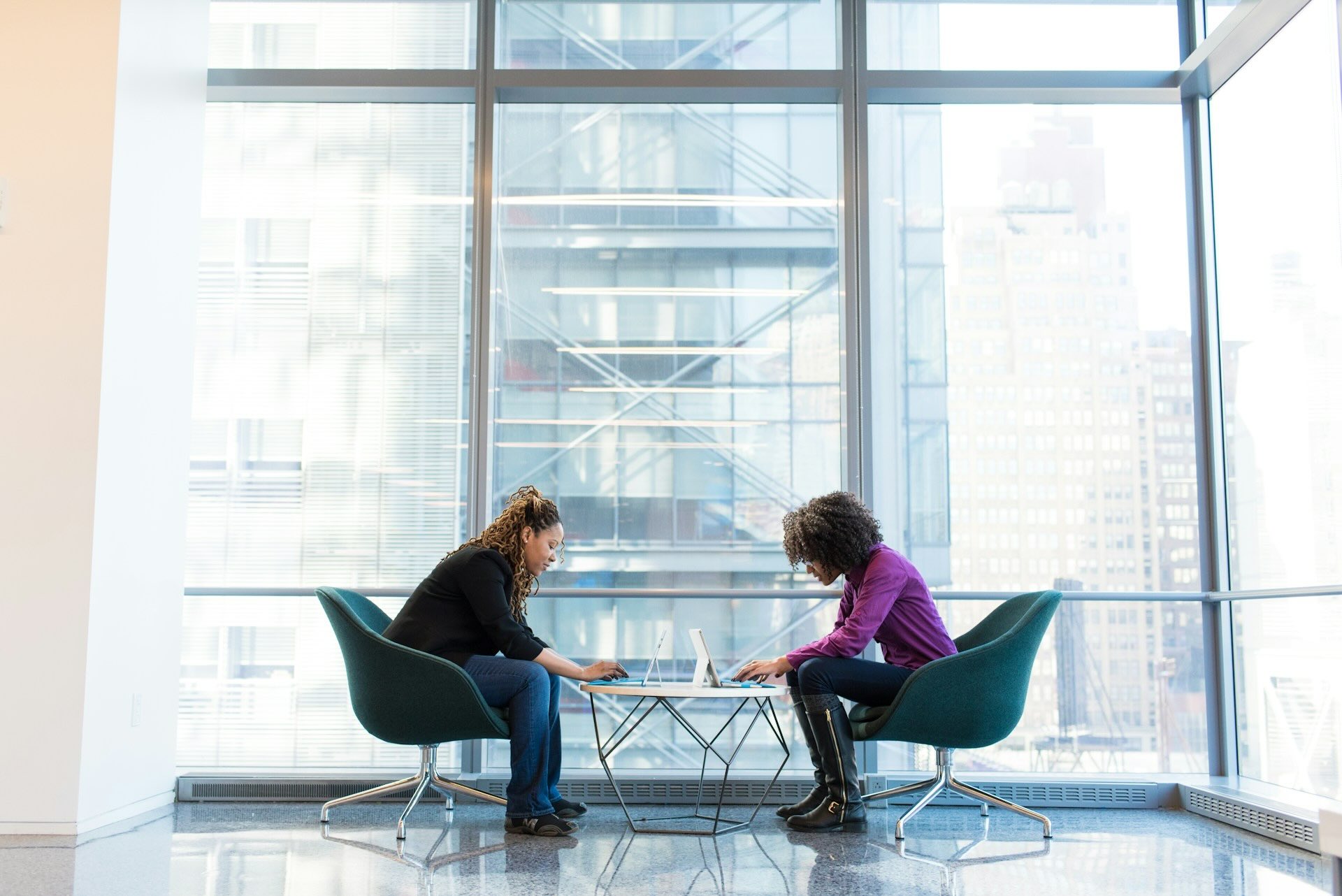 Image of two women sitting at a desk working