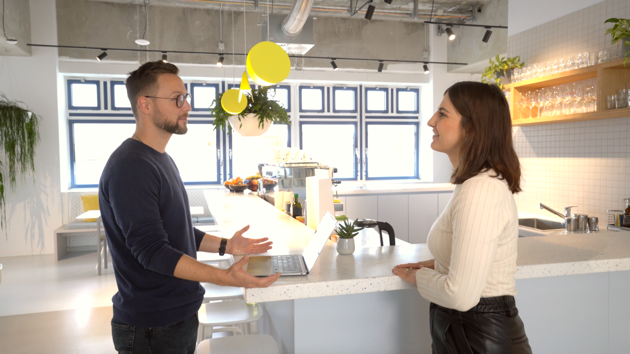 Sales Org intro video cover two people in front of coffee machine