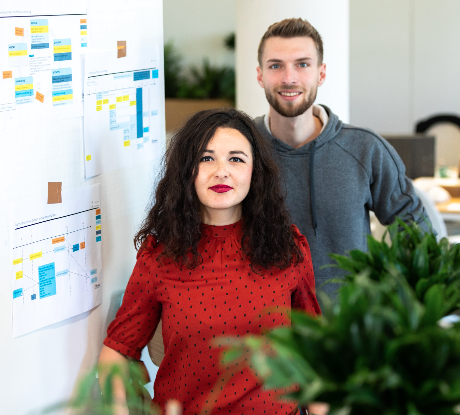 Peers standing next to whiteboard