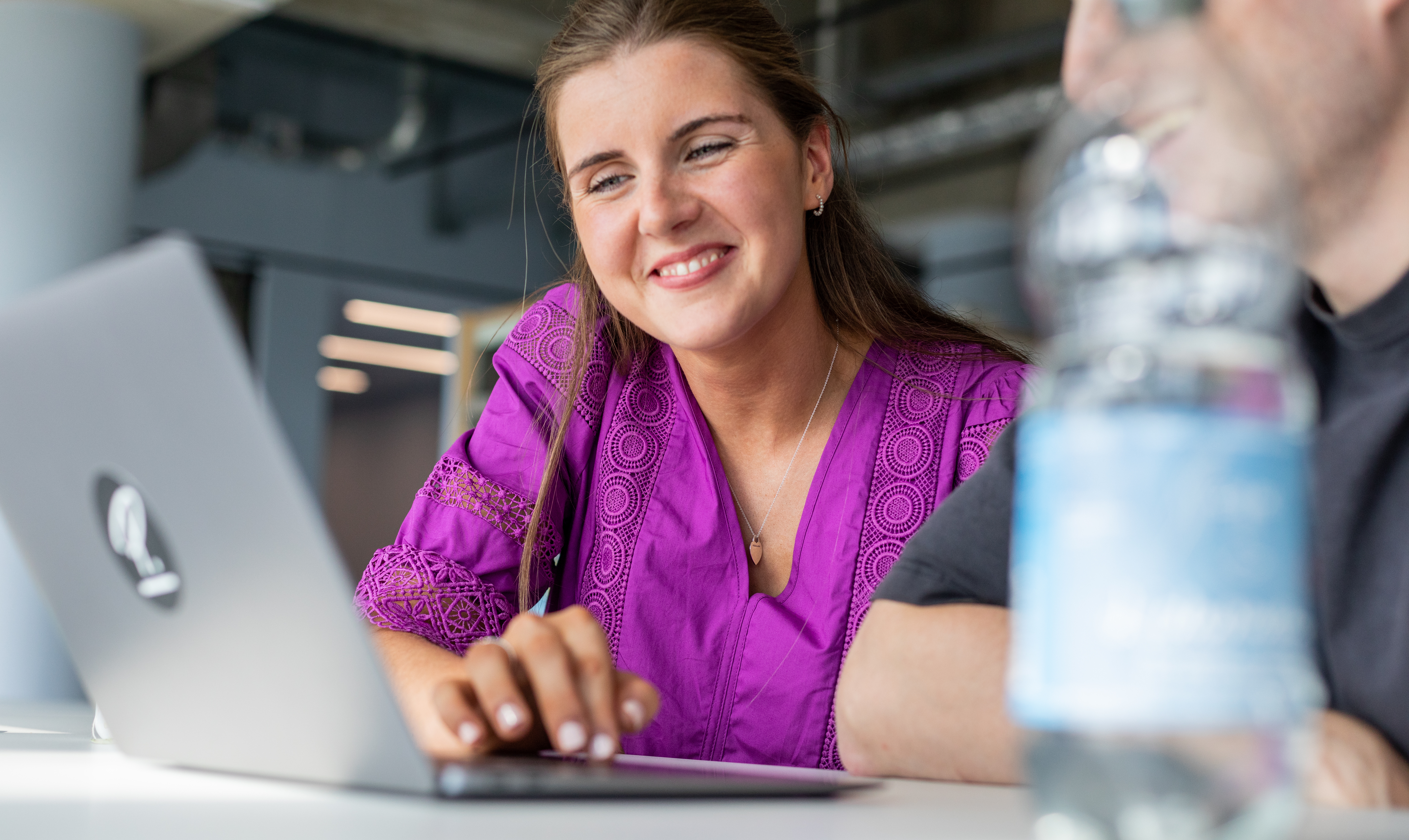 Woman looking at Laptop and Smiling