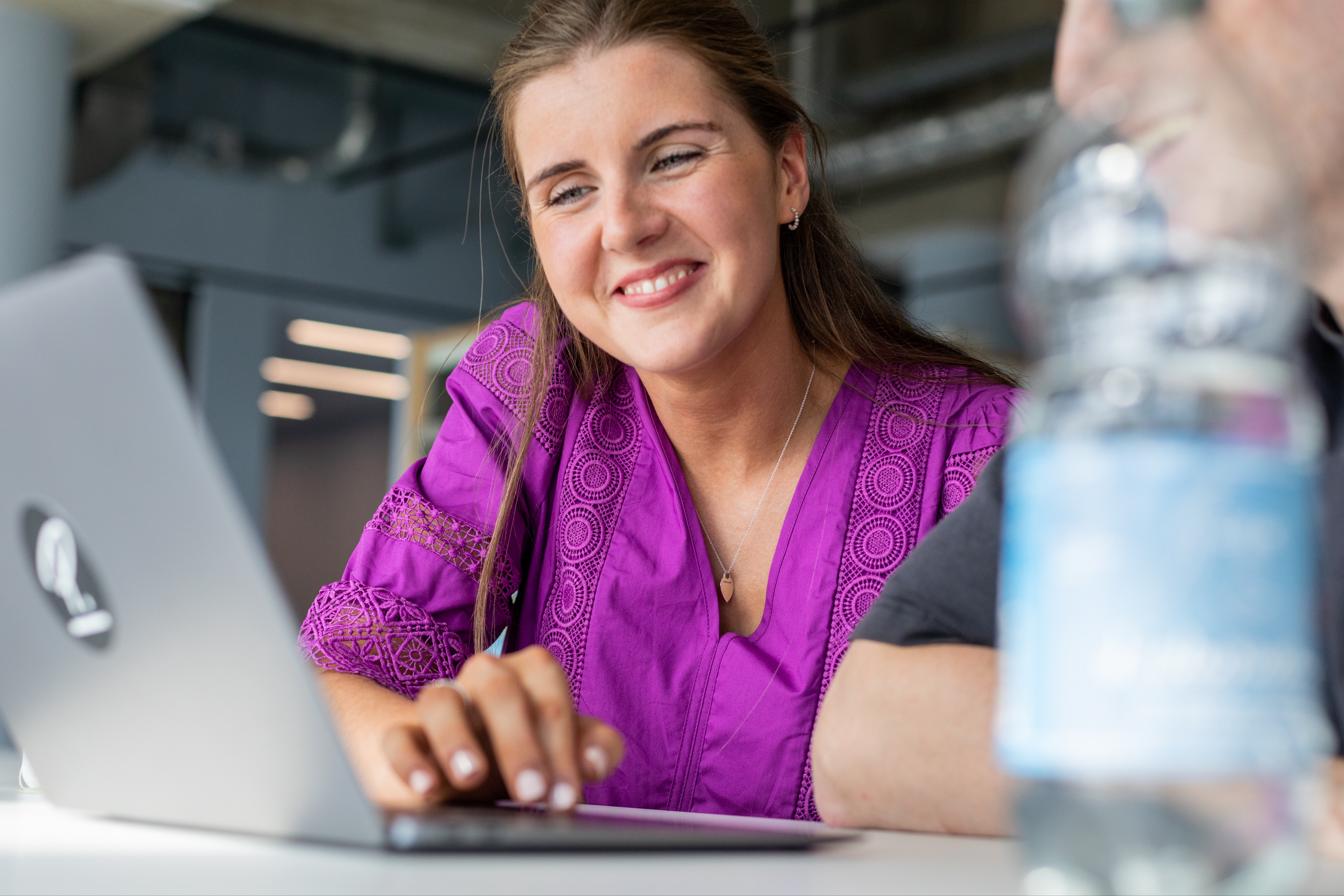 Woman looking at Laptop and Smiling