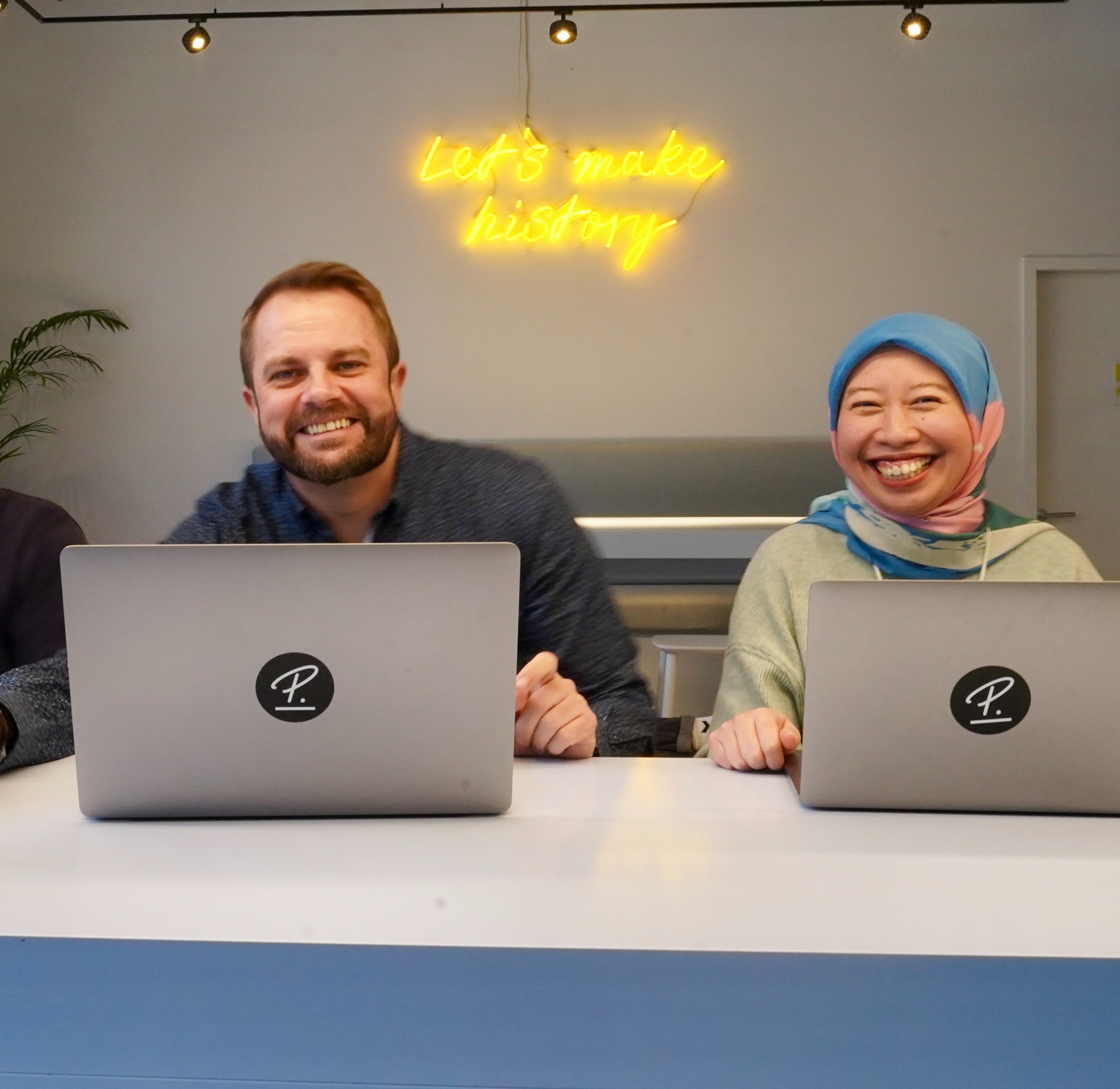 Four members of Data team sitting at table smiling at camera