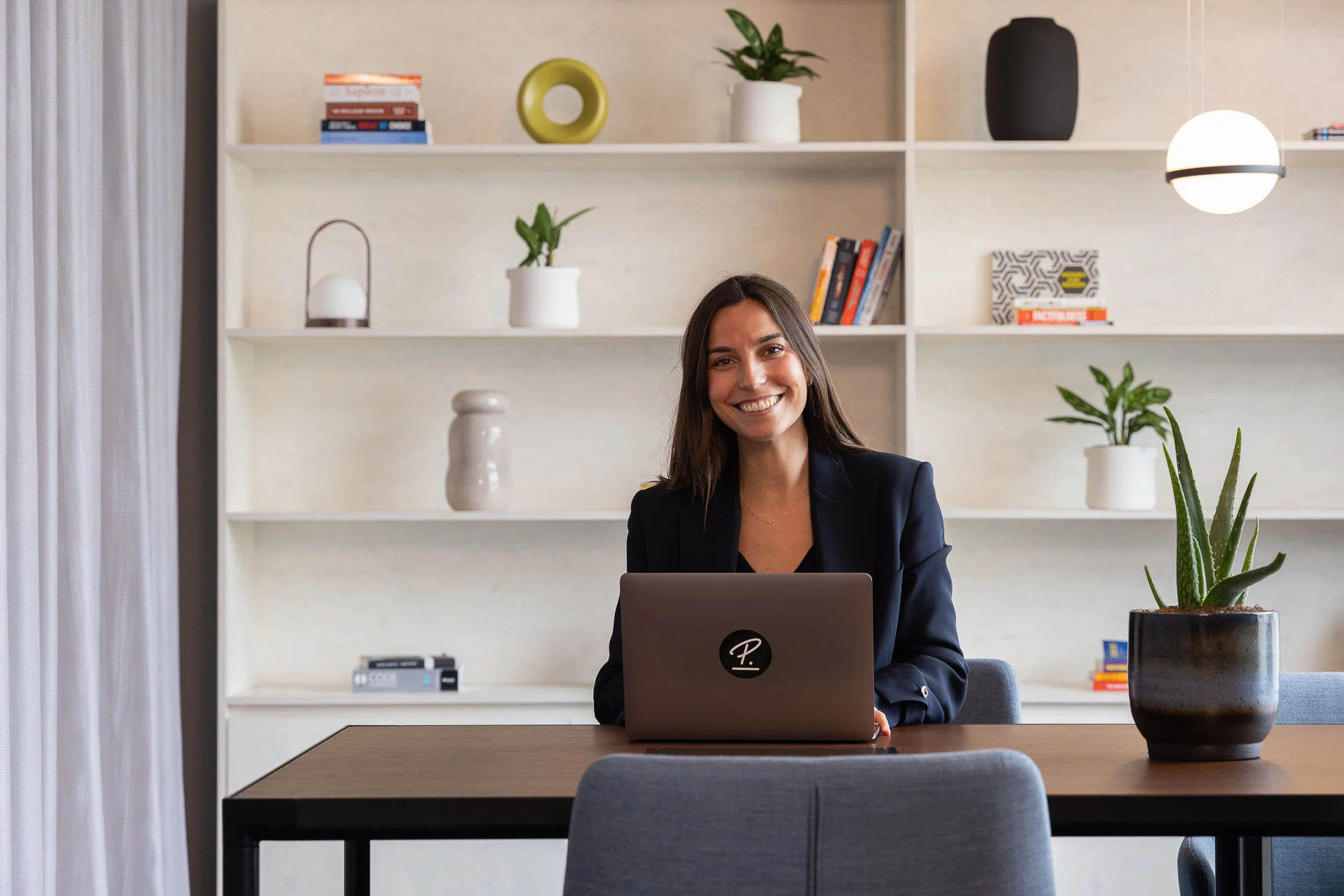 Smiling Personio Employee at Computer