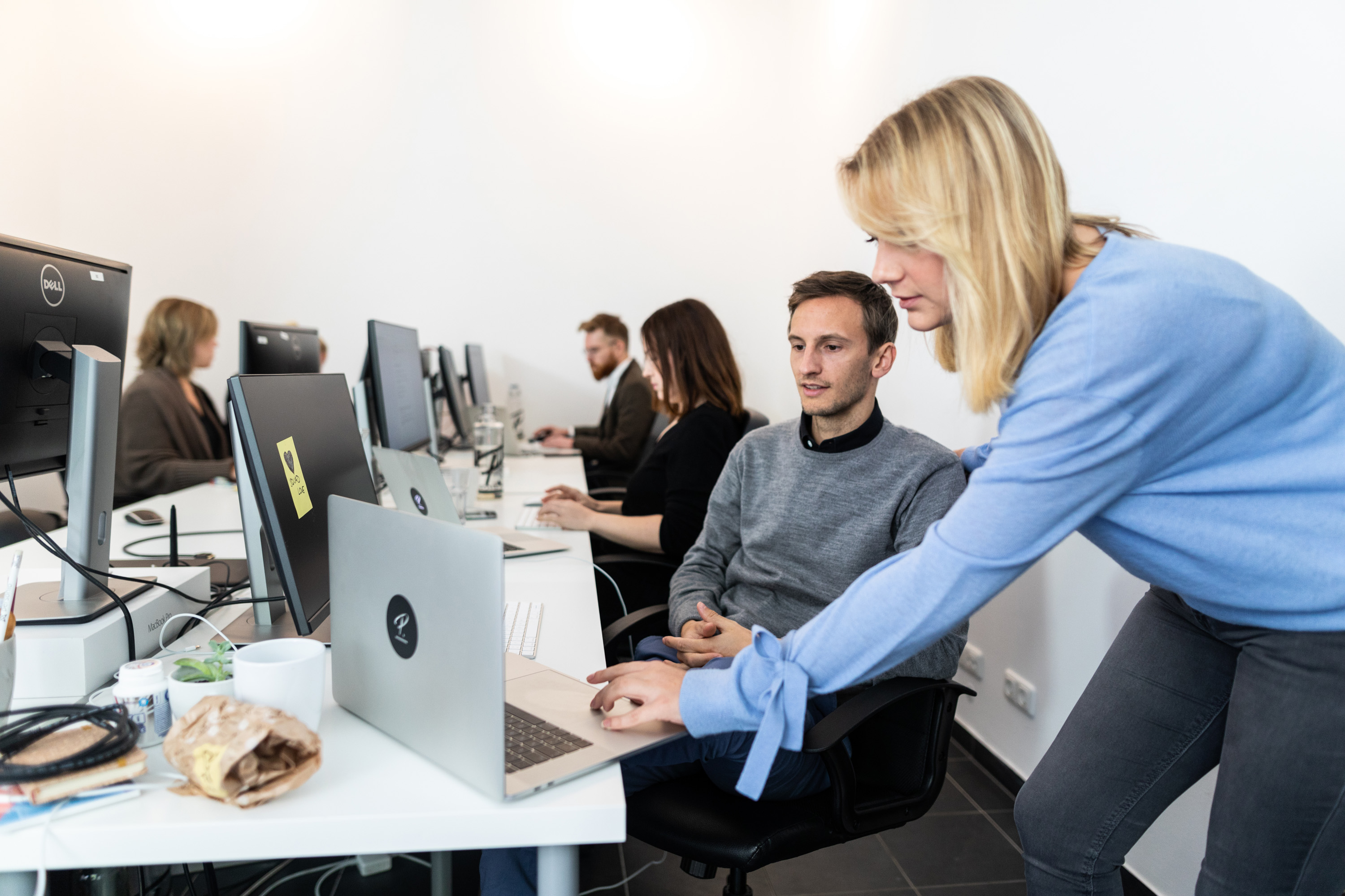 one employee showing another an easy productivity improvement