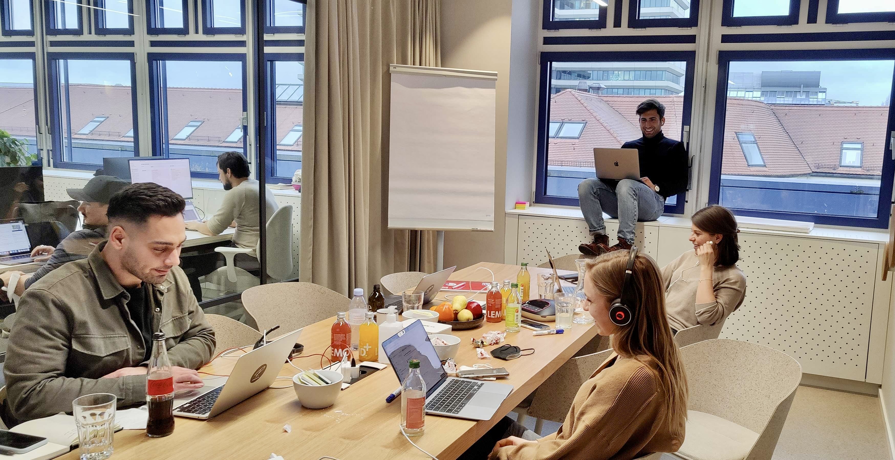 Four Personios in a conference room working together